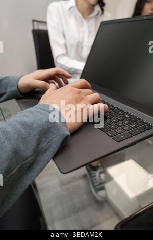 A focused boss writes on a tablet during work, highlighting modern technology, productivity, and professional organization in a business environment. Stock Photo