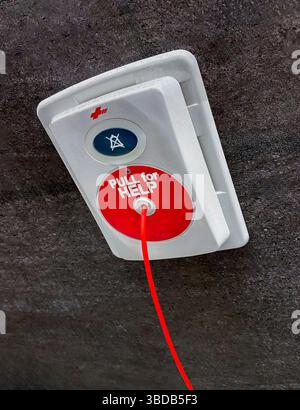 Pull for Help' medical emergency device on bathroom wall in hospital Stock Photo