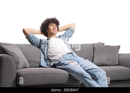 Happy young man relaxing on a sofa isolated on white background Stock Photo