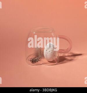 Quail egg with feather in a cup. Happy Easter concept. Close-up. Stock Photo