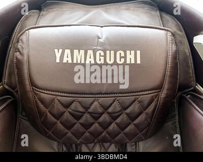 Yamaguchi leather massage chair with quilted pattern and headrest close-up. Stock Photo