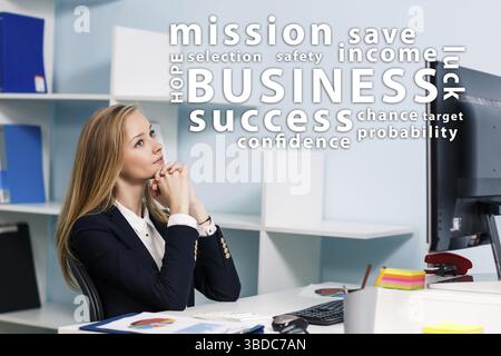 Young pretty business woman looking on word', s cloud in the blue office Stock Photo