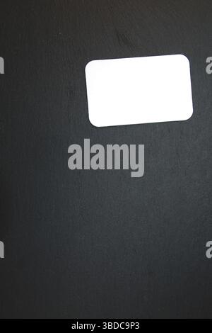 Black slate with white field for notes Blackboard (slate) with blank, writable notepad Stock Photo