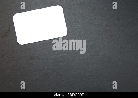 Black slate with white field for notes Blackboard (slate) with blank, writable notepad Stock Photo