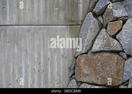 Background retaining wall of large grey stones and concrete wall background concrete and natural stones Stock Photo