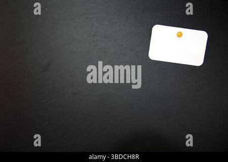 Black slate with white field for notes Blackboard (slate) with blank, writable notepad Stock Photo