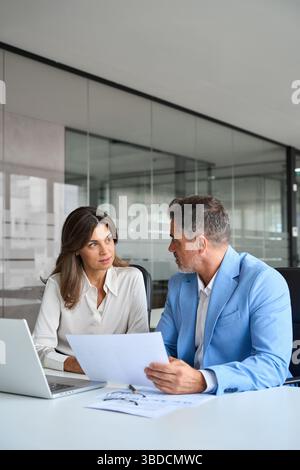 Finance manager and investor discussing corporate project at meeting. Stock Photo