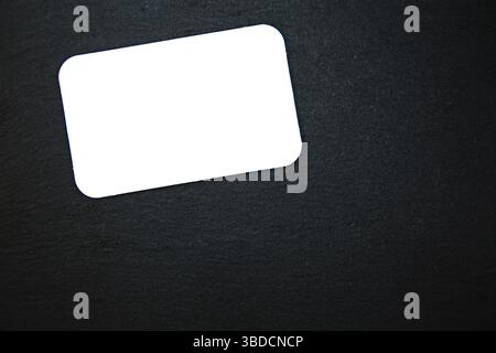 Black slate with white field for notes Blackboard (slate) with blank, writable notepad Stock Photo