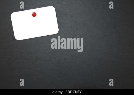 Black slate with white field for notes Blackboard (slate) with blank, writable notepad Stock Photo