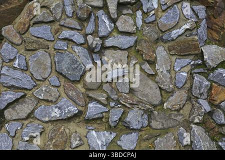 Background retaining wall made of large grey stones Background retaining wall made of grey natural stones Stock Photo