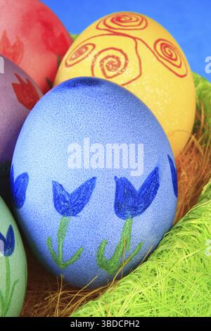 Colorfully painted Easter eggs in green Easter nest Colorfully painted Easter eggs in green Easter nest Stock Photo