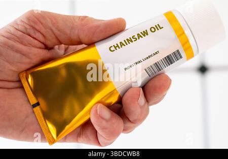 Chainsaw oil. Specially formulated oil for chainsaws to reduce friction and wear on the chain and guide bar. Stock Photo