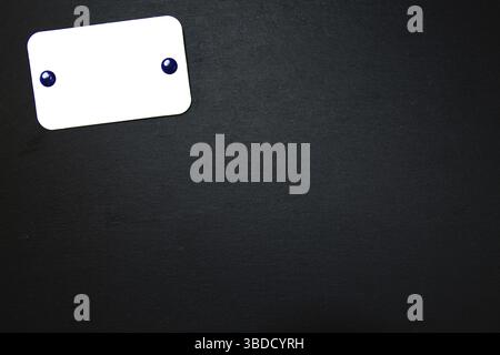 Black slate with white field for notes Blackboard (slate) with blank, writable notepad Stock Photo