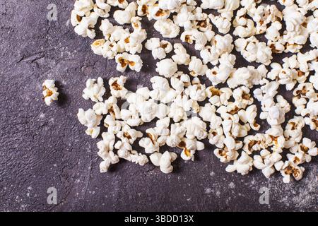 Scattered fresh popcorn on the table, close up top view Stock Photo