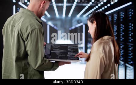 Tech-savvy Engineer Setting Up AI In Data Center Server Room. Stock Photo
