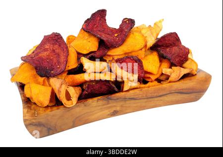 Hand cooked root vegetable crisps made from beetroot, sweet potato and parsnip in an olive wood bowl isolated on a white background Stock Photo