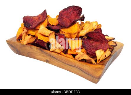 Hand cooked root vegetable crisps made from beetroot, sweet potato and parsnip in an olive wood bowl isolated on a white background Stock Photo