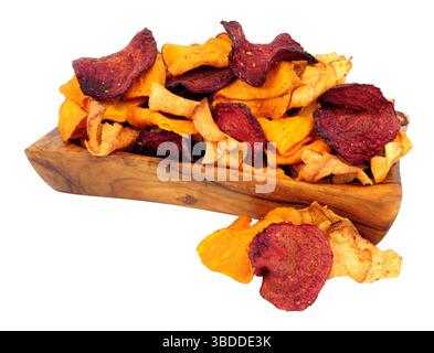 Hand cooked root vegetable crisps made from beetroot, sweet potato and parsnip in an olive wood bowl isolated on a white background Stock Photo