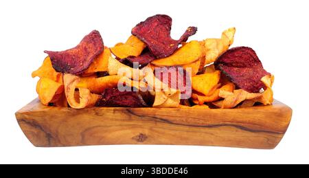 Hand cooked root vegetable crisps made from beetroot, sweet potato and parsnip in an olive wood bowl isolated on a white background Stock Photo