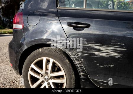 PATRA, GREECE - FEBRUARY 7, 2019: Black Volkswagen Golf scratched in traffic accident. The driver does not pay attention, the vehicle has also very ol Stock Photo