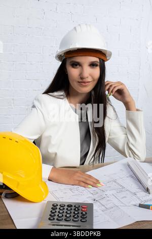 A highly skilled Professional Construction Engineer efficiently managing Blueprints in an Office Stock Photo