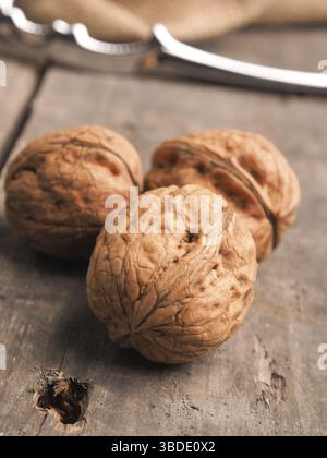Three walnuts on a wooden table, close up shot Stock Photo