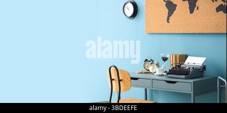 Vintage typewriter with clocks, books and world map on table in office. Banner for design Stock Photo