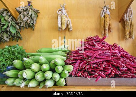Heap of red Borletto beans with corn cobs for sale as vegetable on market Stock Photo