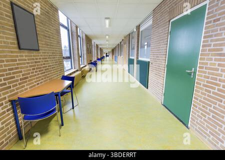 Long straight and empty corridor in college school building Stock Photo
