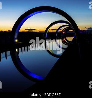 Falkirk, United Kingdom - 19 June, 2022: view of the Falkirk Wheel at sunset with lights in different bright colors Stock Photo