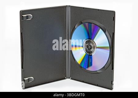 An open black dvd case reveals shiny optical disc inside, reflecting vibrant colors. case is made of plastic and designed to securely hold disc in pla Stock Photo