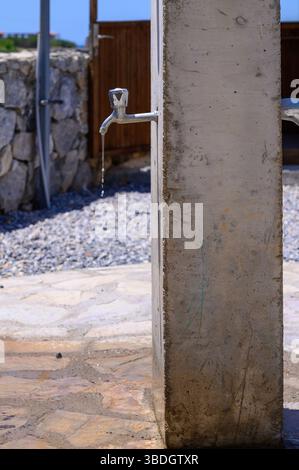 A leaking tap in a bath Stock Photo - Alamy