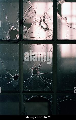 Broken window panes in abandoned building Stock Photo