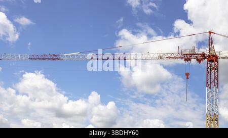 Close up of a stationary crane in the blue sky with clouds moving Stock Photo