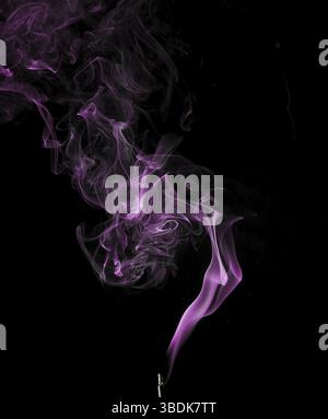 Abstract smoke in purple on a black studio background Stock Photo