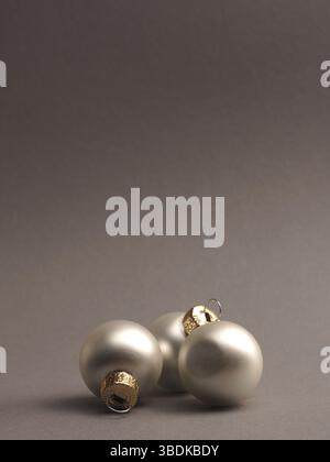 Silver vintage Christmas baubles on a grey background with space for your text or image, seasonal holiday concept Stock Photo
