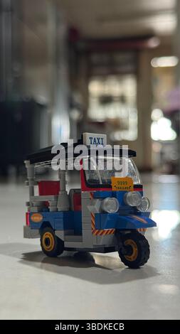 The traditional Thai taxi called TukTuk made of tiny colorful plastic bricks. Stock Photo