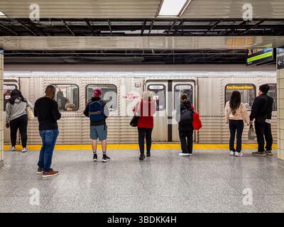 Subway station in Toronto, Canada with people waiting on the platform for a subway train. Stock Photo