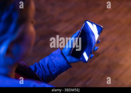 Woman using AI assistant. Using chatbot on smartphone. Artificial intelligence technology. Identity verification. Interaction with AI. Futuristic tech Stock Photo