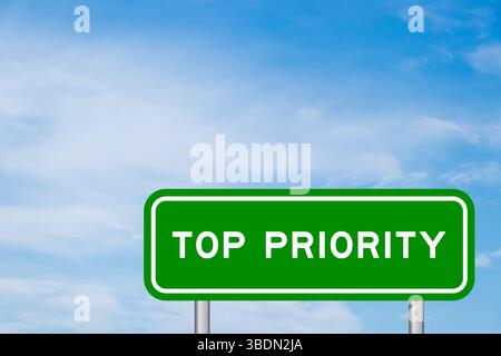 Green color transportation sign with word top priority on blue sky with white cloud background Stock Photo