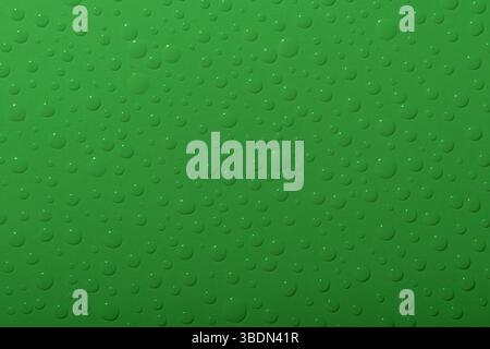 Water drops on green background. Top view. Stock Photo