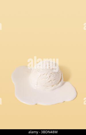Melted ice cream scoop on yellow background. Minimal summer food concept. Stock Photo