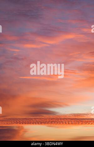 Romantic sky. Incredibly beautiful sunset. Pink clouds. Universal vertical photo. The background picture. Stock Photo