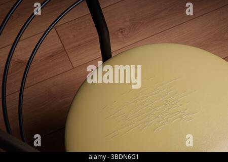 Damaged leather texture on chair upholstery. Restoration and repair, olive leather, background. Stock Photo