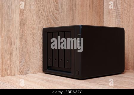 NAS server. Network storage. Device for backing up important information on a brown shelf. Place for text. Stock Photo