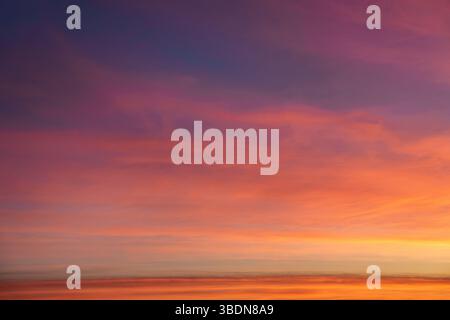 Background image. Incredible sky at sunset. Saturated yellow sky. Lilac clouds. Stock Photo
