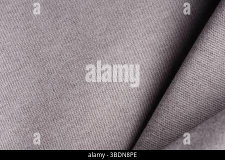 Tweed fabric, wool, gray herringbone textile background. Folded textile. Banner for advertising goods for creativity. Stock Photo