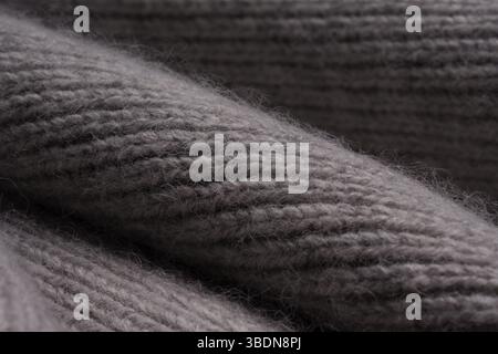 Gray woolen knitted scarf. View texture, close-up macro. Stock Photo
