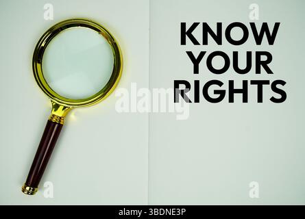 Know Your Rights text with magnifying glass flat lay on notepad background Stock Photo