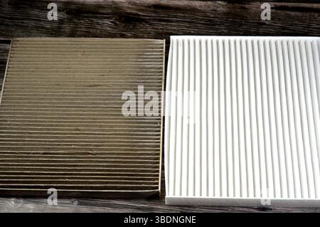 dirty old used car AC air conditioning filter full of dust removed from the vehicle to be replaced with a new one and a new cabin air carbon filter, r Stock Photo